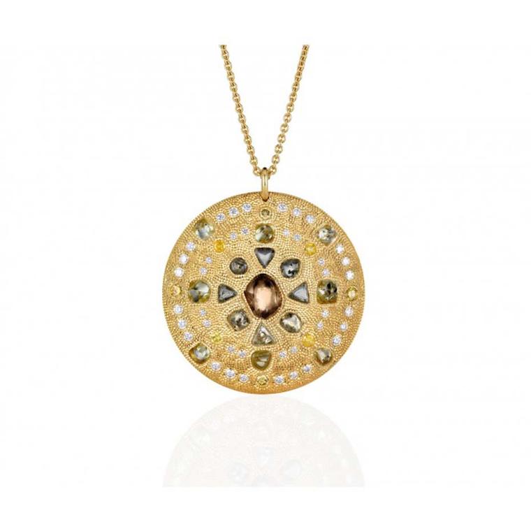 The De Beers Talisman Virtue Strength medallion necklace in yellow gold, set with rough green, brown and yellow diamonds, measures 44m across.